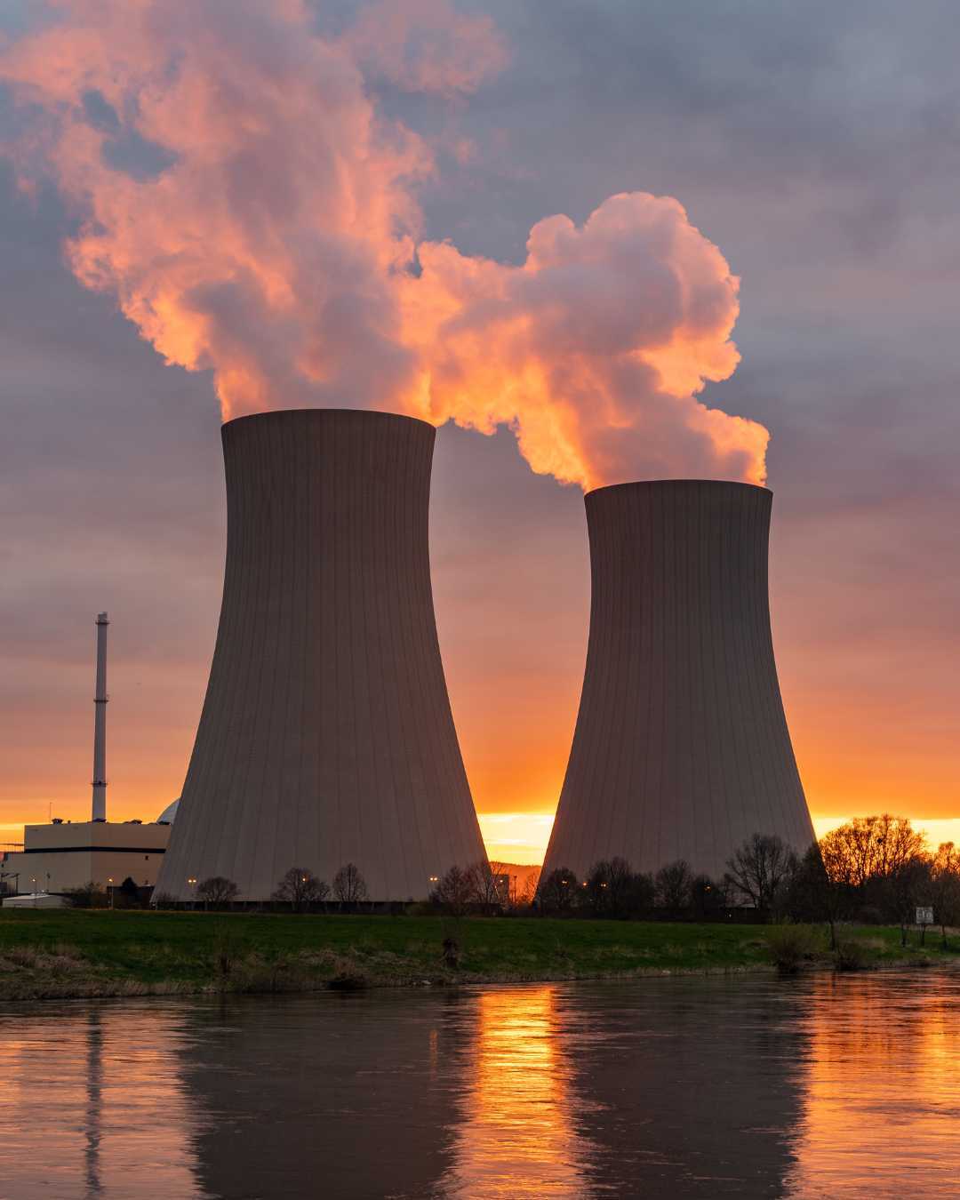 A power plant and cooling towers at sunset A power plant and cooling towers at sunset